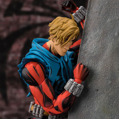 Action figure in red and blue costume climbing a rock